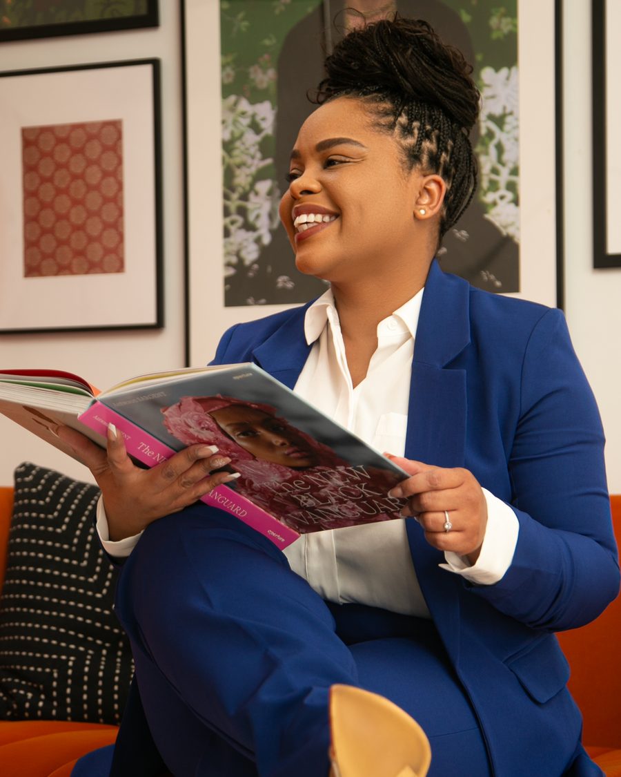 Attorney Jennifer Brantley smiling in a cobalt blue suit while reading a book