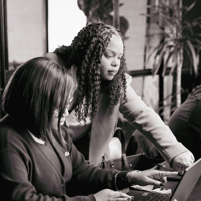 Helping an attendee work through a search on her laptop.